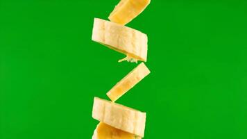 Banana Slices Falling in Front of a Green Screen for Use in Editing and Compositing video
