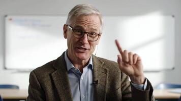 Man in Classroom Explains Topic With Finger Raised During Daytime Lecture video