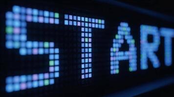 Close-up of a digital screen displaying the word 'START' in pixelated letters, signifying the beginning of something new and innovative video