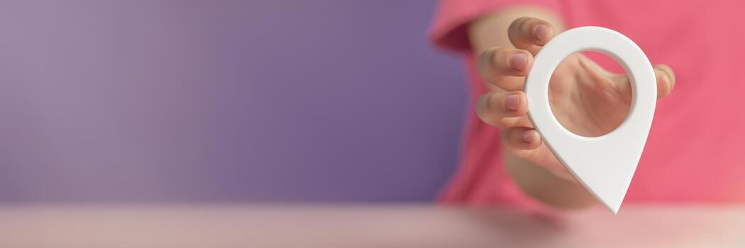 A hand holds a location sign on a purple background. Laying a route, finding the location of a point on the map. Pin icon sign or navigation map locator travel GPS direction pointer. photo