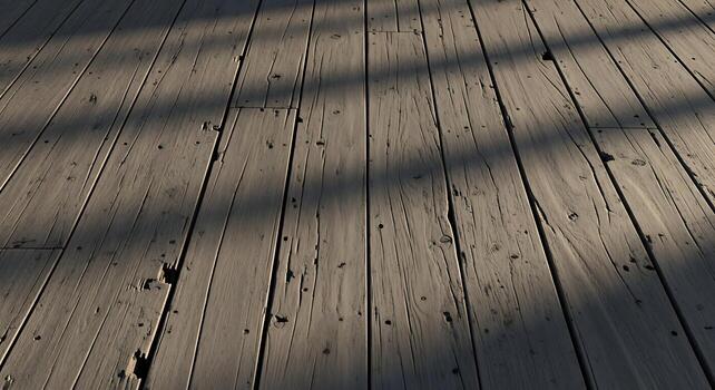 Weathered wooden floorboards with shadows creating a textured pattern and rustic ambiance for photo