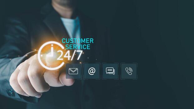 A businessman's hand points to a glowing 24 customer service icon on a virtual screen, which displays various contact options for providing continuous, round-the-clock support. photo