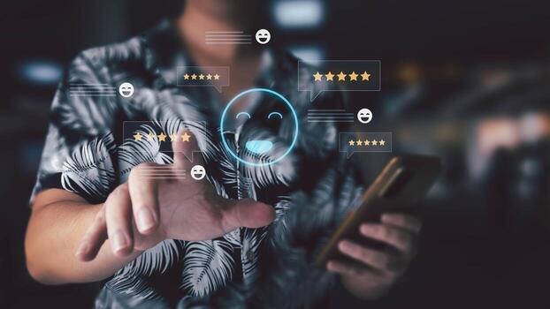 A man uses a smartphone to interact with a virtual interface displaying customer satisfaction ratings and feedback icons. photo