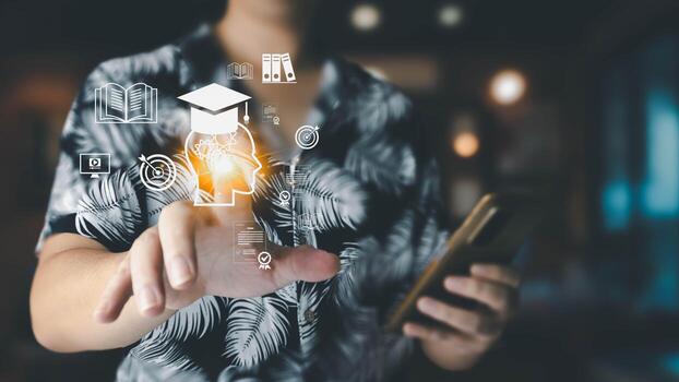 A man interacts with a virtual interface featuring educational icons like a graduation cap and books, symbolizing access to online learning and skill development through modern technology. photo
