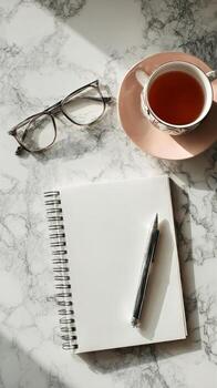 Minimalist Workspace With Coffee, Glasses, Pen, and Notebooks on Marble Table. photo