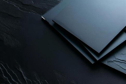 Black Textured Folders Stacked on a Dark Surface With Subtle Patterns Visible in the Background photo