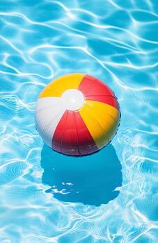 Colorful Beach Ball Floating on Clear Water in Summer Pool Scene. photo