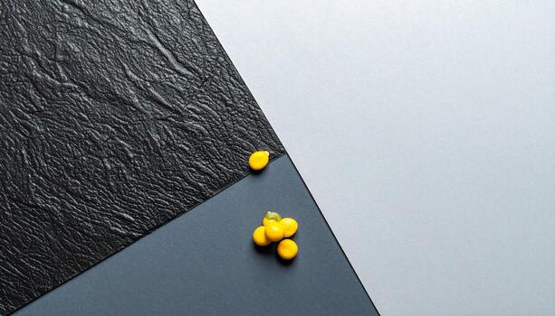 Abstract Geometric Composition Yellow Capsules on Textured Black Surface Gray Background photo