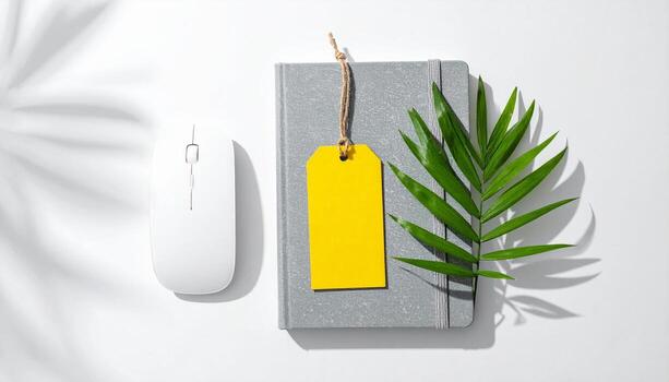 Top View of Modern Office Flat Lay Grey Notebook White Mouse Yellow Tag and Green Leaf with Palm Shadows photo