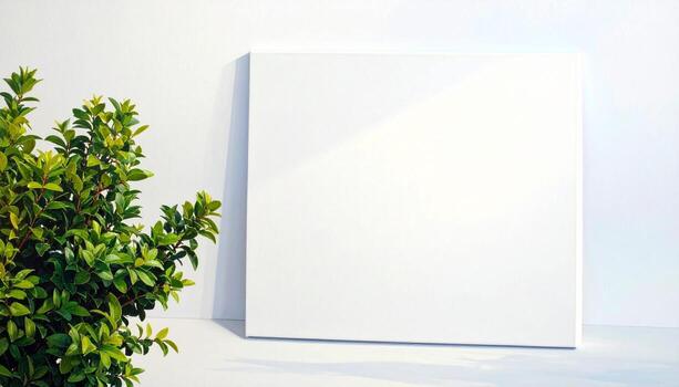 Blank Canvas on White Surface with Green Plant and Soft Light for Mockup Design photo