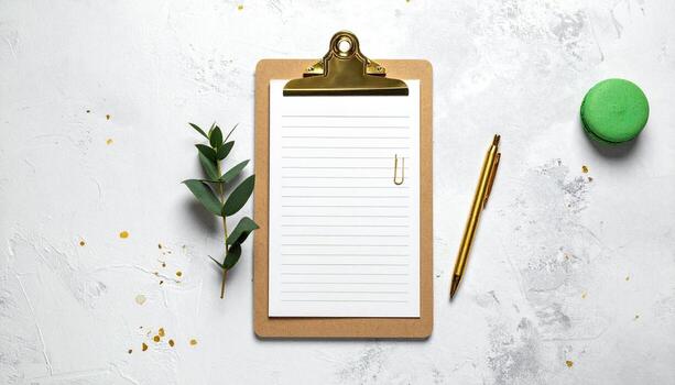 Flat lay of a clipboard blank lined paper gold pen eucalyptus branch and green macaron on a textured white background with gold confetti ideal for notes planning or creative ideas photo