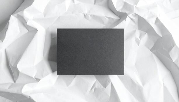 Minimalist Dark Card Mockup on Textured White Crumbled Paper Background photo