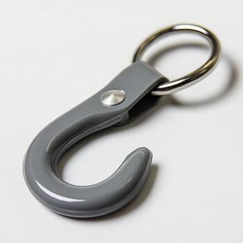 A gray hook with a silver ring on a white surface close up photo