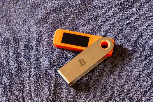 Hardware wallet displayed open on textured surface in indoor setting. photo