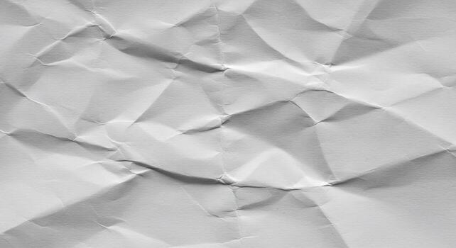 Abstract crumpled white paper texture with dramatic shadows and sharp folds photo