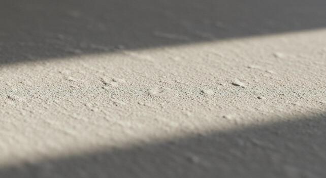Textured Concrete Surface with a Diagonal Shadow Line, Close-Up View photo