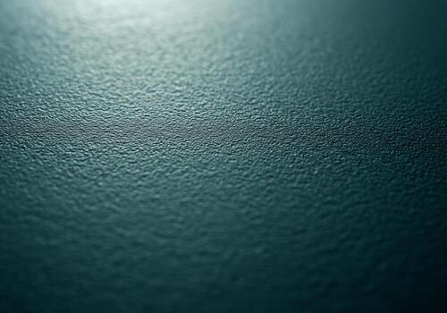 Textured teal surface with subtle light creating a calming and abstract background photo
