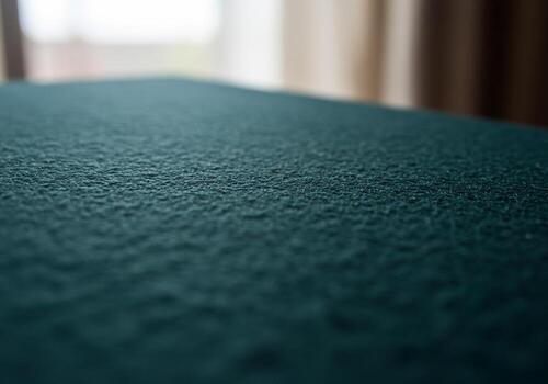 Closeup of textured teal surface with blurred background creating depth and visual interest photo