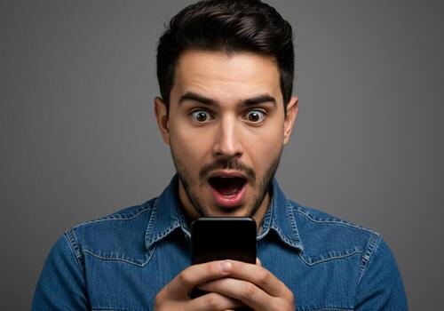 Man Expressing Shock While Using Smartphone photo