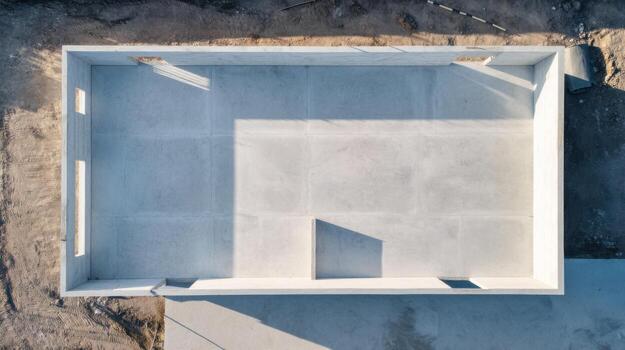 View from above of new rectangular concrete structure under construction at building site photo