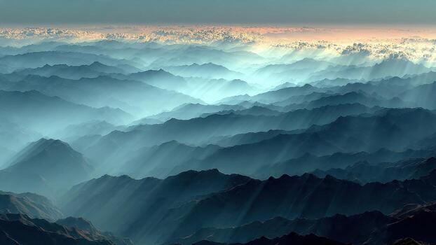 Dramatic mountain range landscape with crepuscular rays piercing through atmospheric haze photo