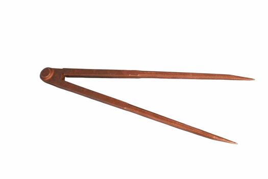 Tool for precise measurements made of metal, showcasing pointed tips and an adjustable hinge for versatility in craft and design photo