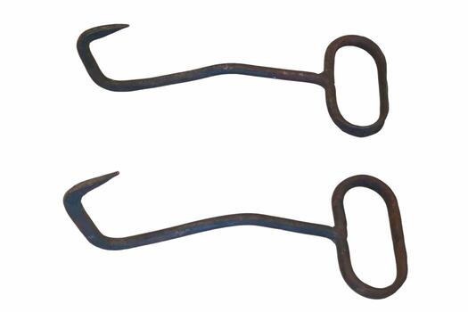 Iron tools used for lifting or handling heavy items during work or farming tasks in a workshop setting photo