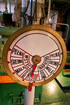 Gauge showing operational levels in an industrial setting during daytime with machinery in the background photo