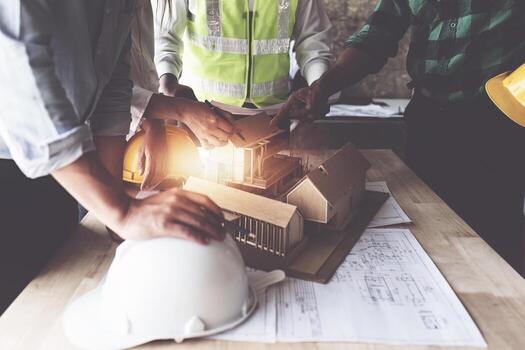Close up Architect team working with blueprints for architectural plan, engineer sketching a construction concept. photo