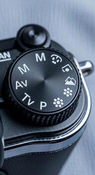 Close up of a digital camera mode dial showing manual aperture priority shutter priority and program settings photo