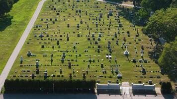 A drone view showing many rows of tombs and place of sorrow and memory. Cemetery on bright sunny day video