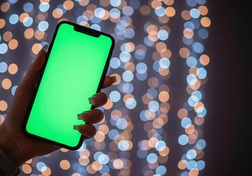 Mockup woman hand holding using smart phone with green blank screen, mobile close up photo