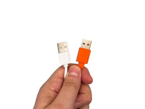 Close up USA type C, USB type A, micro usb, chargers, type c, white usb, orange usb. A hand holding two different colored cords photo