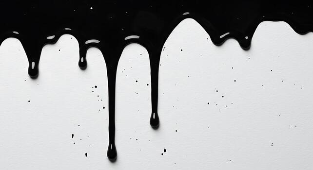 Black paint dripping down a white surface, creating an abstract pattern. photo