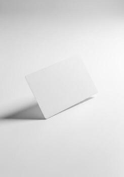 A photorealistic 3D render of a single blank white business card or credit card mockup, elegantly angled on a clean studio background with soft shadow for branding photo