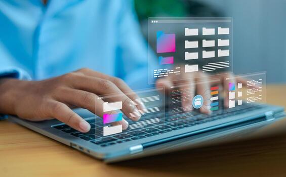 Hands typing on laptop with digital file folders interface, cloud computing and data management concept photo