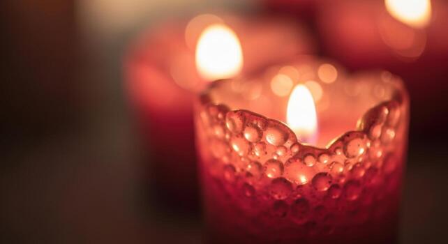 Warm and Intimate Close up of a Vibrant Red Candle in a Textured Holder with Bokeh Lights photo