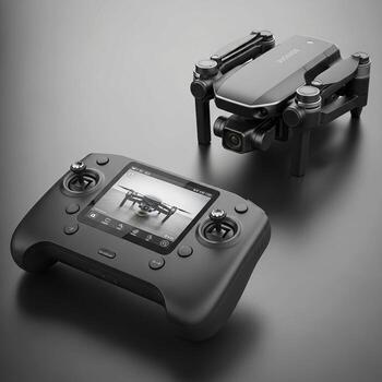Compact foldable drone and its advanced remote controller with integrated screen presented on a dark surface photo