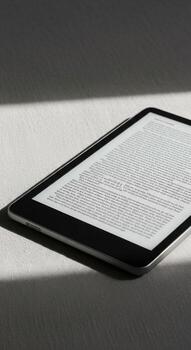 A tablet computer with a book open on it photo