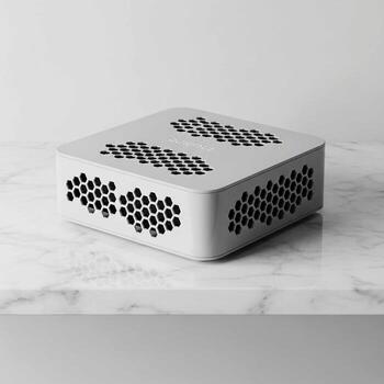 Compact white computer tower with hexagonal ventilation pattern on a light marble surface photo