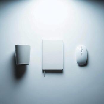 Minimalist desk setup featuring a white mug notebook and computer mouse on a clean white surface photo