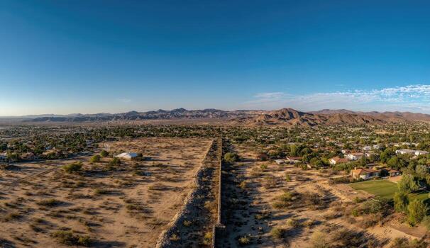 Aerial view of a desert landscape with a wall photo
