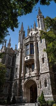Gothic architecture building entrance, trees, blue sky photo