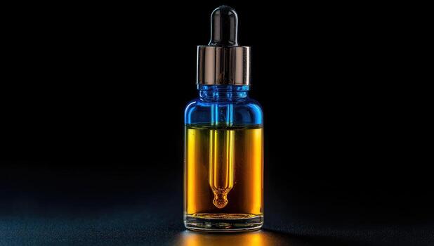 Blue and gold dropper bottle on dark background photo