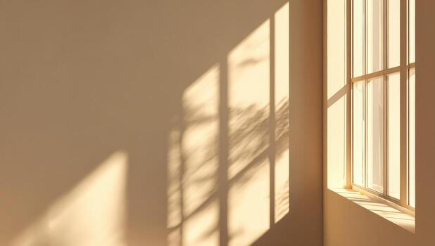 Sunlight casts shadows on a beige wall beside a window photo
