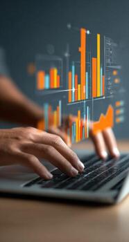 Hands typing on a laptop with holographic charts overlay photo