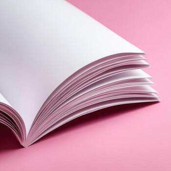 Open book, blank pages, pink background photo