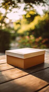 Light beige box on wooden table, garden backdrop photo