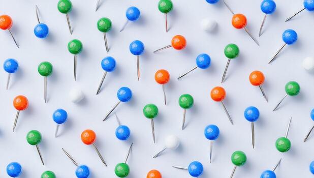 Colorful pushpins on a light blue background photo