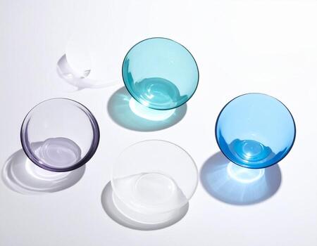 Overhead View of Colorful Glass Bowls with Shadows on White Surface. photo